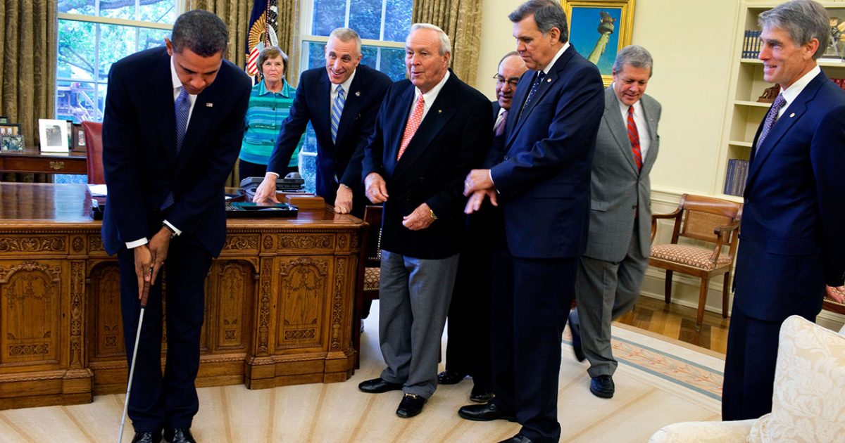 Barack Obama takes a practice putt in the Oval Office 1